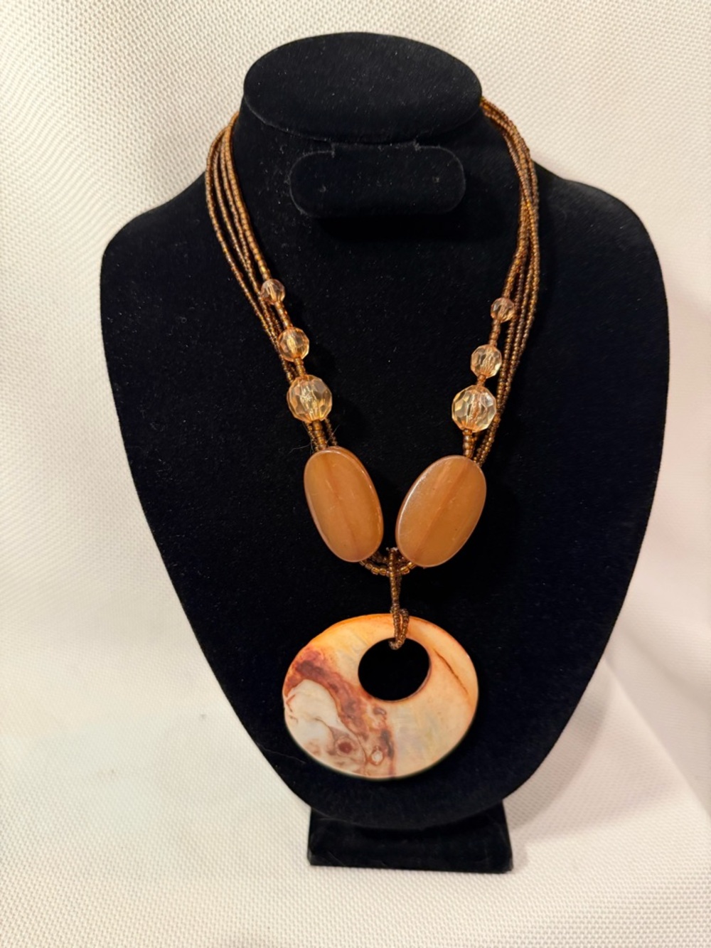 Multi-Strand Brown and Cream Necklace with shell pendant